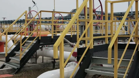 Powerful production area or facility with pipes and stairs. Distiller of crude. Stock Footage 199487514