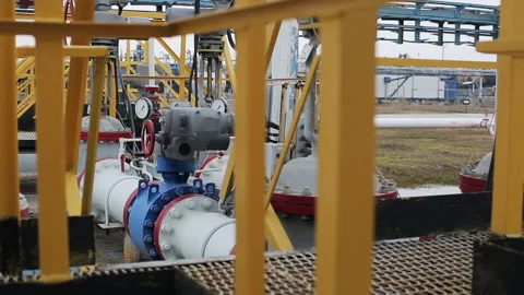 Powerful production area or facility with pipes and valves. Distiller of crude. Stock Footage 199487522