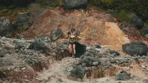 Powerful Queen Commanding the Elements in a Volcanic Canyon Stock Footage 237481157