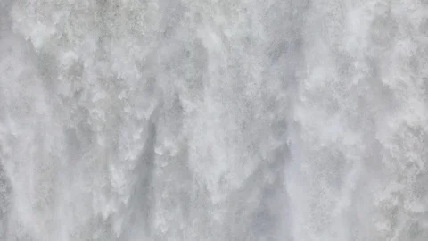 Powerful raging whitewater waterfall falling forcefully over a rocky Видео 96252336