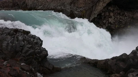 Powerful raging whitewater waterfall falling forcefully over a rocky Stock Footage 96253104