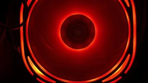 Powerful red illuminated computer fan providing essential cooling inside a PC Stock Photos