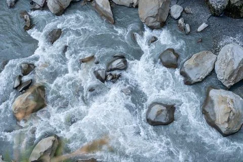 Powerful river rapids flowing over large natural rocks Stock Photos