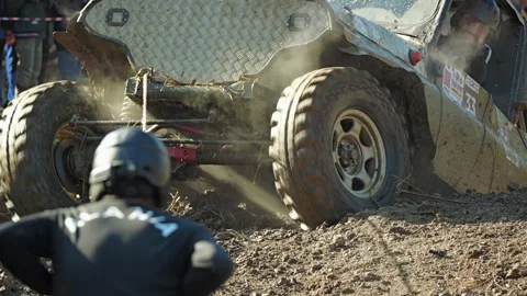 A powerful off-road vehicle churns through mud, its spinning wheel Stock Footage 345495186