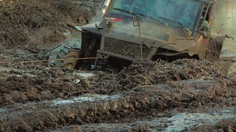 Powerful off-road vehicle stuck deep in thick mud during an extreme motorsports Stock Footage 344876930