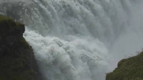 A powerful, roaring waterfall splashing violently over a cliff edge. Stock Footage 335959966