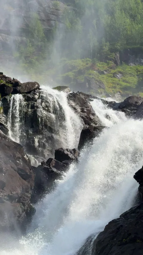 Powerful rocky waterfall cascading down a mountain forest Stock Footage 324597712
