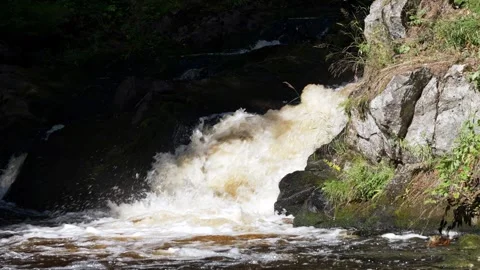 Powerful rushing waterfall flowing down rocks Stock Footage 345551448