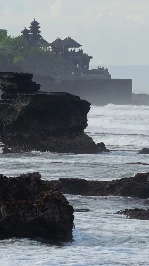 Powerful Sea Boulder In Front With Temple Background And Rough Waves Видео 330974495
