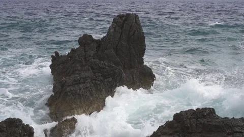 Powerful sea waves beat against a coastal cliff. Foam and drops. Stock Footage 125613327