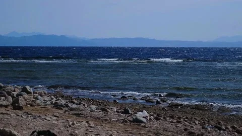 Powerful sea waves break on the coast of the Red Sea. Waves crash on a pebble be Stock Footage 236571077