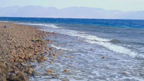 Powerful sea waves break on the coast of the Red Sea. Waves crash on a pebble be 스톡 동영상 236571163