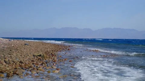 Powerful sea waves break on the coast of the Red Sea. Waves crash on a pebble be 스톡 동영상 236571250