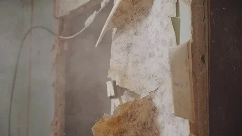 Powerful Sledgehammer Strike Shatters Interior Wall in Dramatic Slow Motion Stock Footage 337930472
