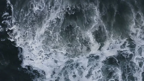Powerful slow-motion waves crash to shore after storm, top down aerial Stock Footage 112714578