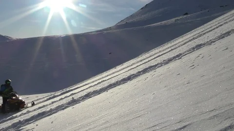 Powerful snowmobile leaves trace and raises frozen snow dust Video stock 112533232