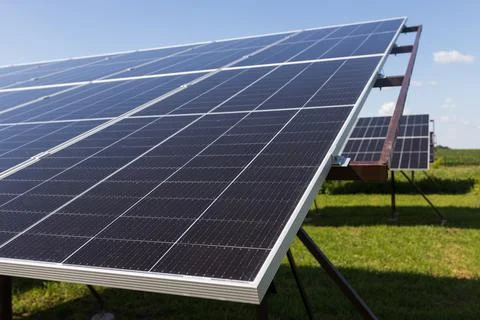 Powerful solar panels on blue cloudy sky background Stock Photos