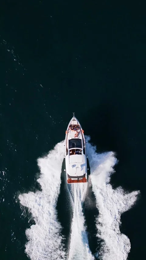 A powerful speedboat cuts through the open sea, leaving a striking wake behind Video stock 281763507