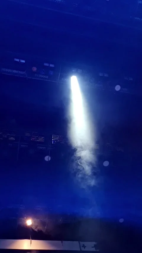 A powerful spotlight cuts through the blue haze Stock Footage 293675635