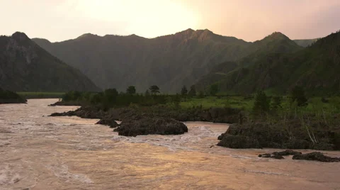 Powerful stream of Katun river in Altay mountains over sunset Stock Footage 67354592