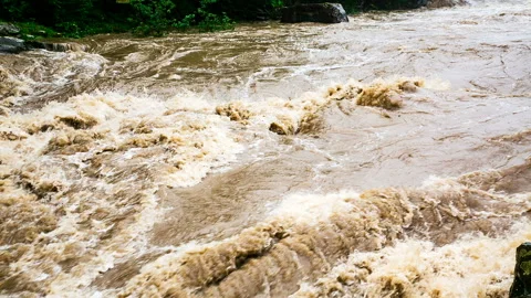 A powerful stream of a mountain river flows through stone rapids. Waterfall 스톡 동영상 132898402