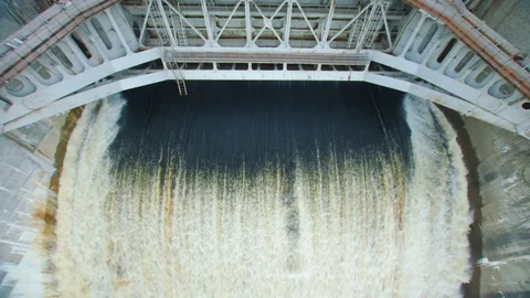 Powerful stream of water falls from the shutter in the dam, hydroelectric Stock Footage 78706976