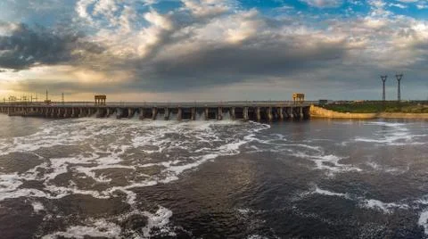 Powerful stream of water falls from the shutter in the dam, hydroelectric Stock Photos