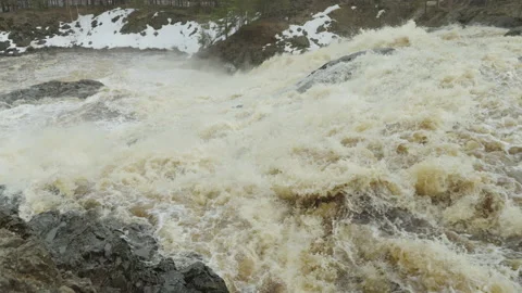 A powerful stream of water flowing over the rocks. Slow motion video. Video stock 190605495