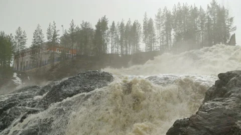 A powerful stream of water flowing over the rocks. Slow motion video. Видео 194361074