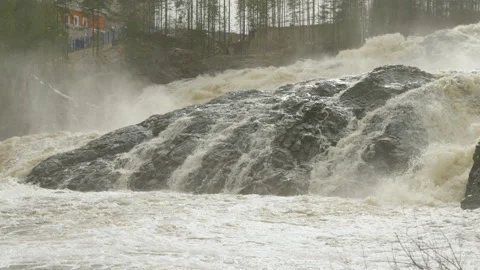A powerful stream of water flowing over the rocks. Slow motion video. Video stock 194361432