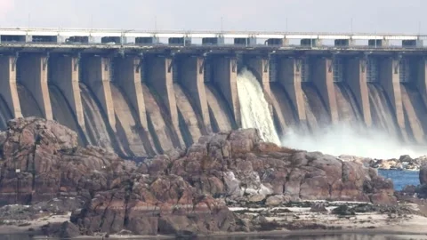 A powerful stream of water flows out of the concrete dam spillway Video stock 323222334