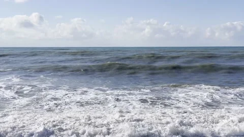 The powerful surf of the waves and the foam of the sea break on the shore. Video stock 228812582