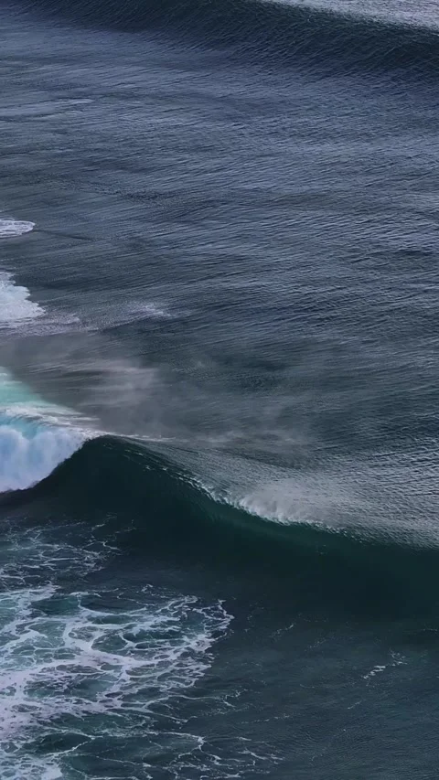 Powerful Surf Waves Crashing with Misty Spray Under Overcast Skies Stock Footage 334794475