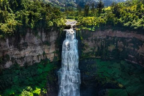 Powerful Tequendama waterfall plunging into deep canyon surrounded by lush green Stock Photos