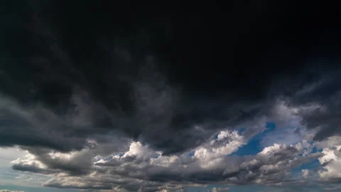 Powerful timelapse showing dark storm clouds surrounding a bright opening of... Stock Footage 340199217