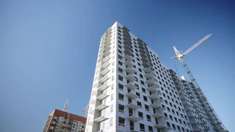 Powerful tower cranes assemble multistory apartment building Видео 330991343