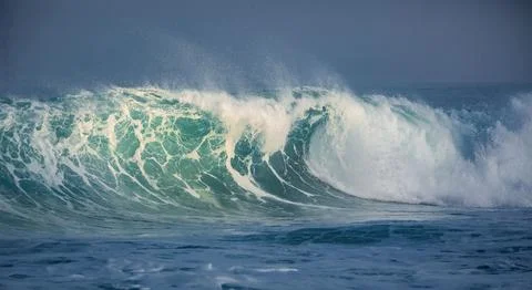 Powerful Turquoise Ocean Wave Cresting and Breaking in Deep Blue Sea Stock Photos
