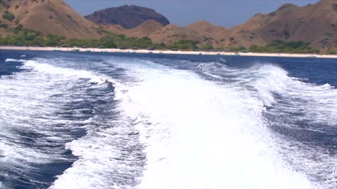 Powerful wake and large ocean waves generated by a fast boat sailing Stock Footage 341269048