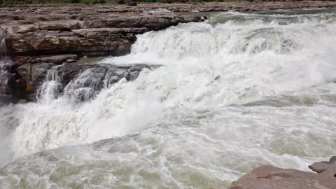 Powerful water cascading over rocky cliffs at the Huanghe Hukou waterfall Stock Footage 342102175