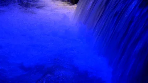 Powerful water flow with artistic blue lighting. Stock Footage 93354185