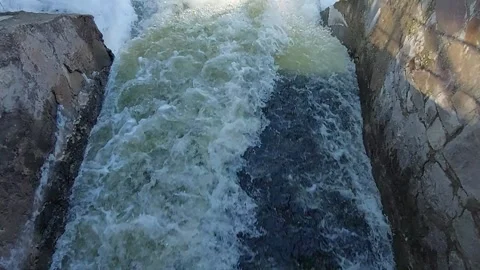 Powerful water flow from a dam with a small rainbow Stock Footage 330400708