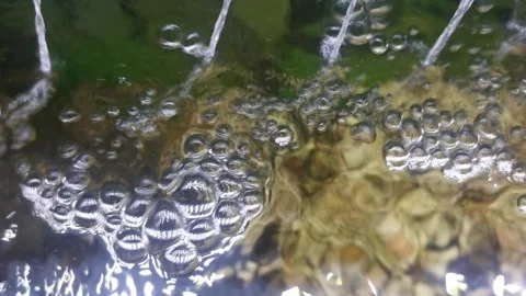 Powerful Water Flow from Four Sources Creating Dynamic Ripples Video stock 311133443
