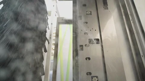 Powerful water jets spraying from a modern automatic car wash system during a Video stock 340230723