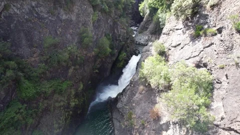 A powerful waterfall and a river surrounded by mountainous walls Video stock 307140506
