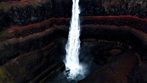 Powerful waterfall cascading down a lush, green cliffside. Stock Footage 297845784