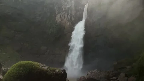 Powerful Waterfall Cascading Down Rocky Cliff, Misty Natural Landscape Stock Footage 325646361