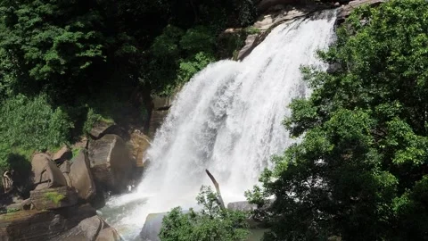 Powerful waterfall cascading down rocky cliff Stock Footage 337767436