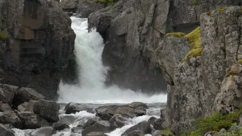 Powerful waterfall cascading down rocky cliffs in the wilderness of Iceland Stock Footage 339775761