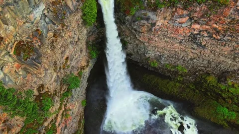 Powerful waterfall cascading down rocky cliff drone shot Stock Footage 344137832