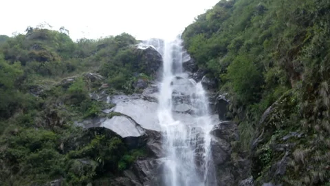 Powerful Waterfall Cascading Down Rocky Cliff Surrounded By Lush Green Forest Vídeos de archivo 346198762